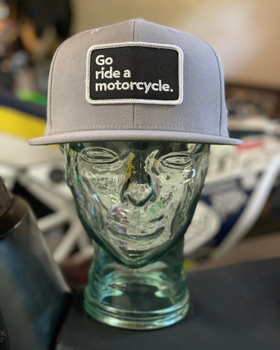 "Go ride a motorcycle" grey snapback flat brim hat from Crown Moto