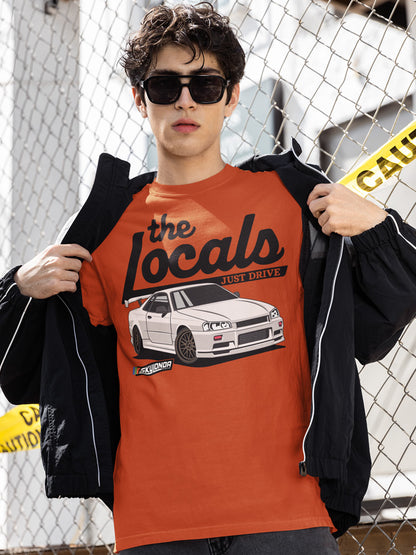 young man wearing sunglasses and a red Locals Just Drive R34 t-shirt