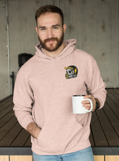 Man wearing a sand colored Moto is Life pullover hoodie with a cup of coffee in his hand