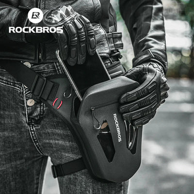 Person holding a black tool with 'RockBros' branding, wearing gloves and a leather jacket.