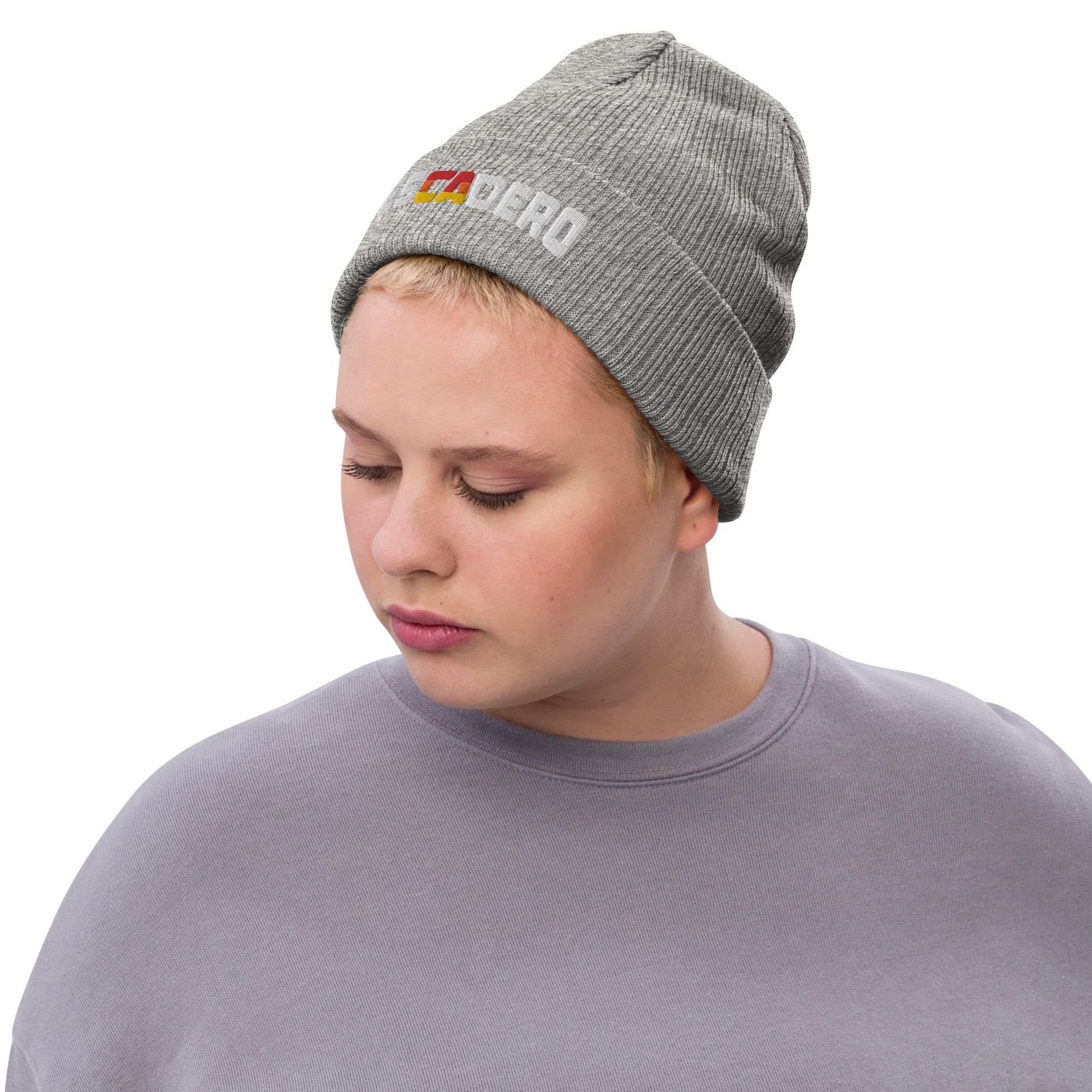 Woman wearing Pescadero Sunset embroidered ribbed knit beanie