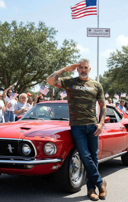 Man saluting in front of a red Mustang with an American flag in the background