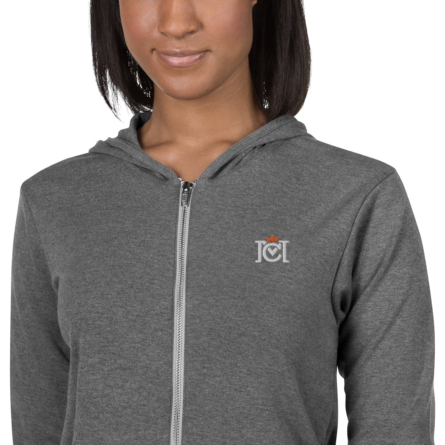 Woman wearing lightweight full zip hoodie with trademarked crown moto logo embroidered on left chest