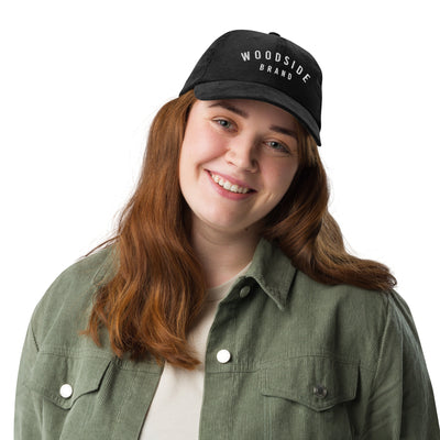female model wearing a black vintage corduroy woodside brand hat