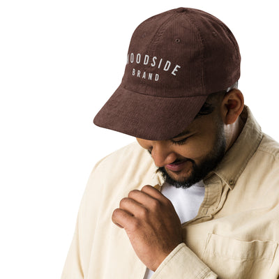 male model wearing a vintage corduroy woodside brand hat