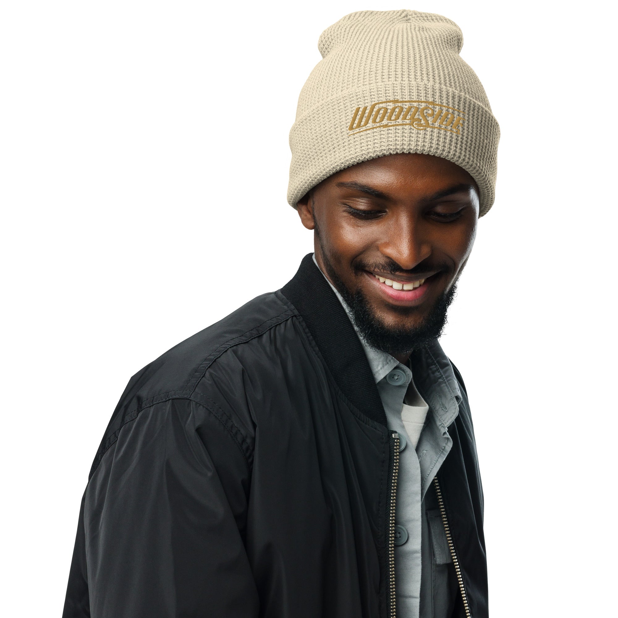 Male model wearing a Woodside brand waffle knit beanie with Woodside Brand logo embroidered in gold on front cuff