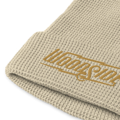 Product mockup of Woodside brand waffle knit beanie with Woodside Brand logo embroidered in gold on front cuff