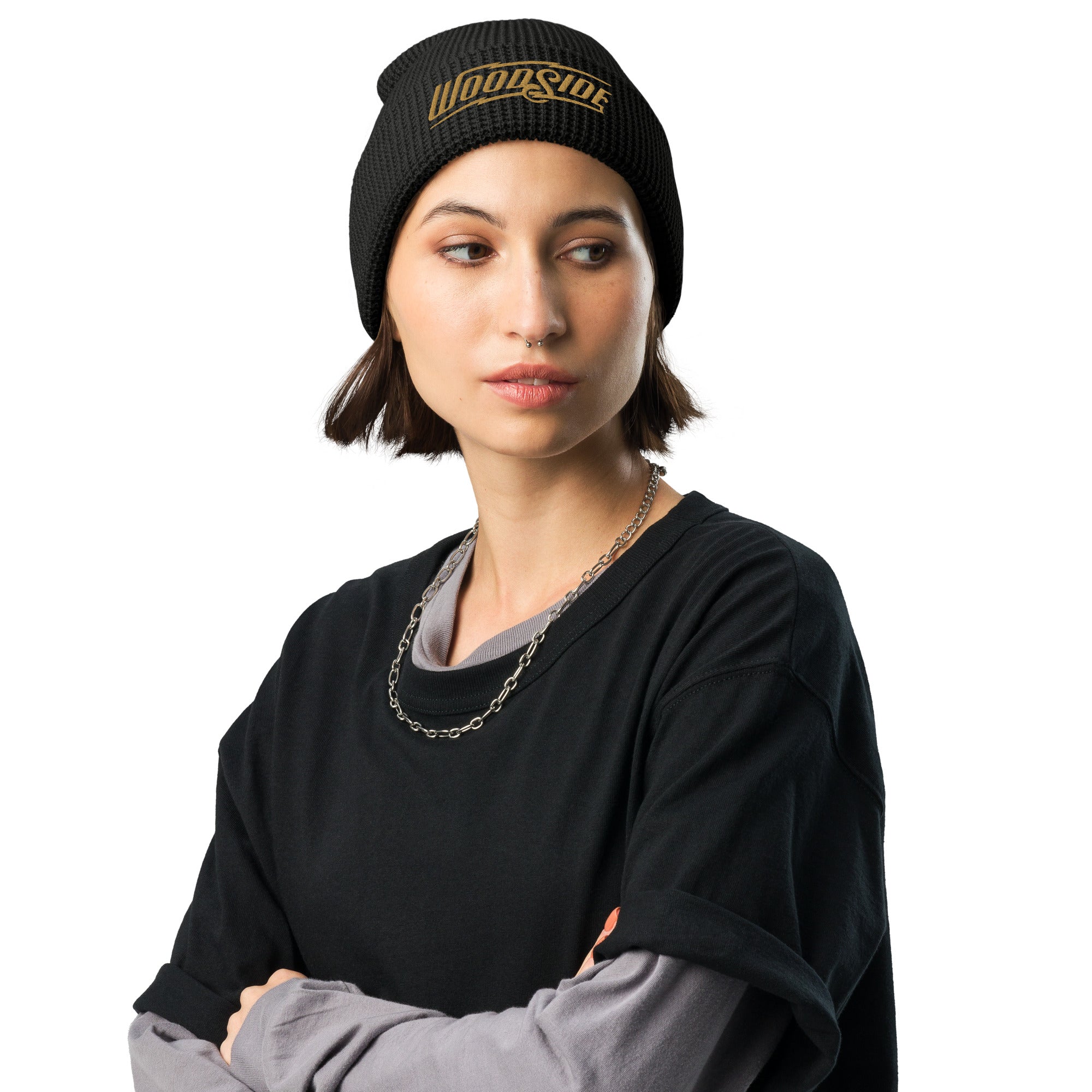 Female model wearing a Woodside brand waffle knit beanie with Woodside Brand logo embroidered in gold on front cuff