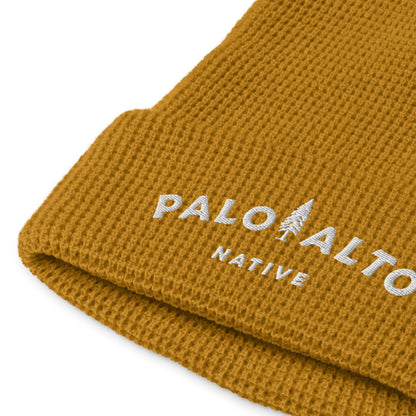 Product mockup of Palo Alto Native waffle knit beanie with "palo alto native" logo embroidered in white on front cuff