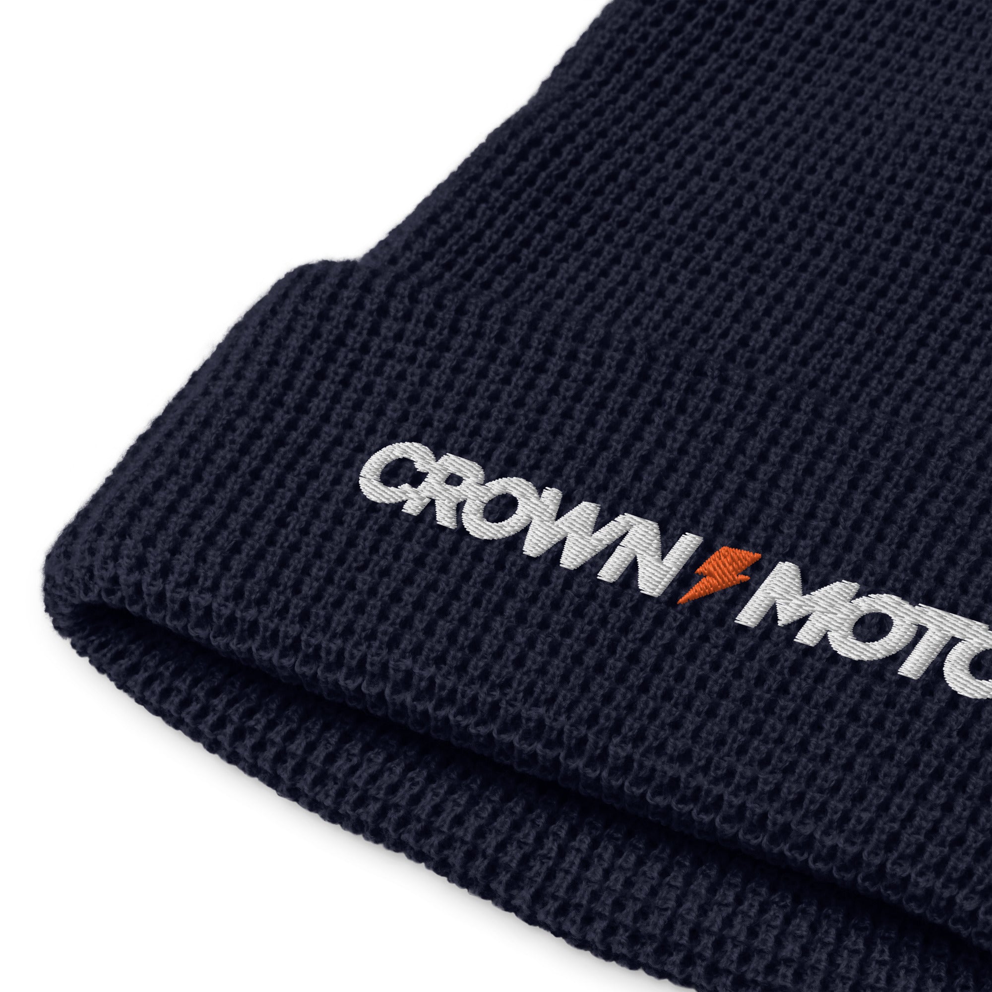 "crown moto" with orange lightning bolt embroidered on cuff of waffle knit beanie