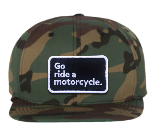 "Go ride a motorcycle" patch sewn on front of Yupoong green camouflage snapback hat