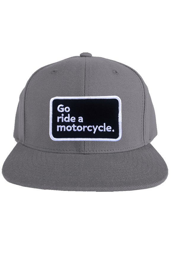 "Go ride a motorcycle" patch sewn on front of snapback hat